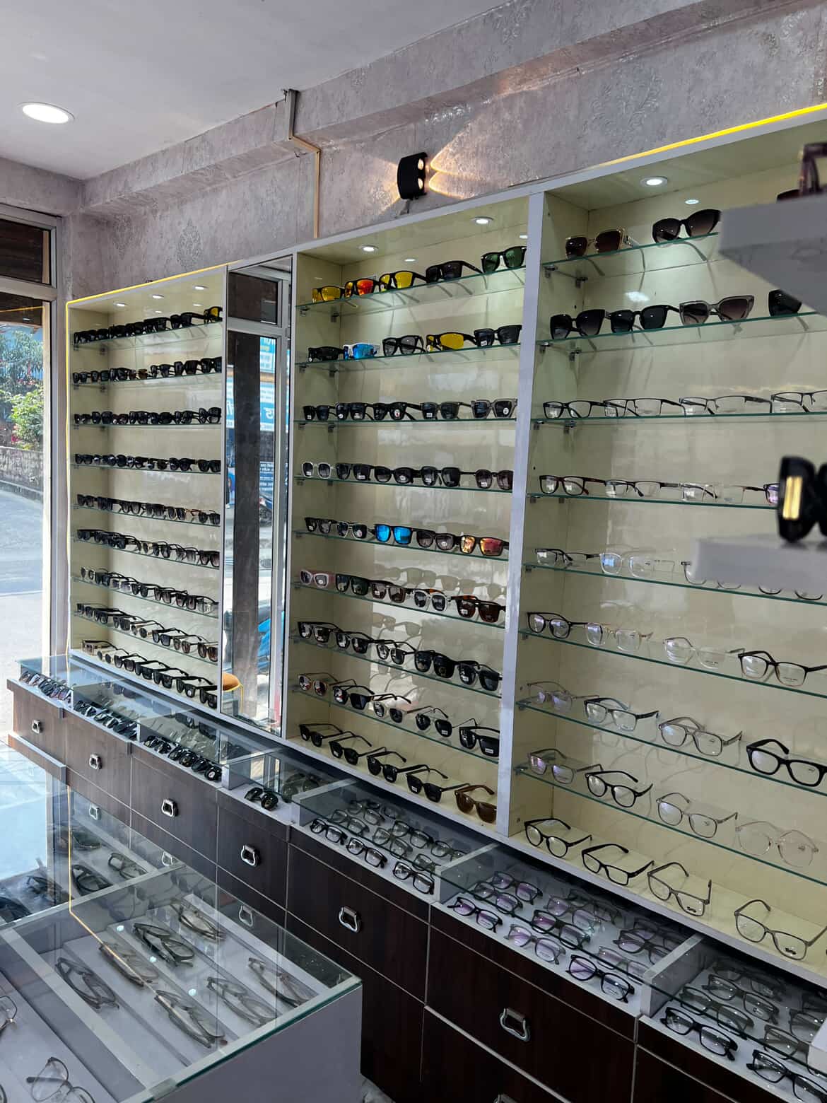 Navya Drishti eyewear collection display with prescription frames and sunglasses